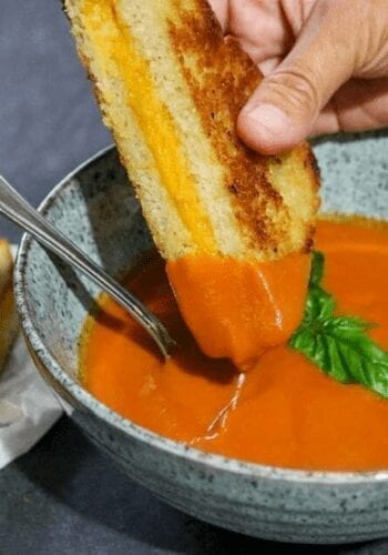 Dipping grilled cheese into vegan tomato soup