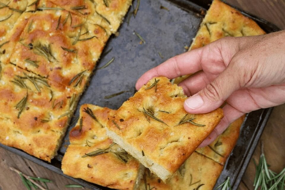 Grabbing a piece of roasted garlic and rosemary focaccia